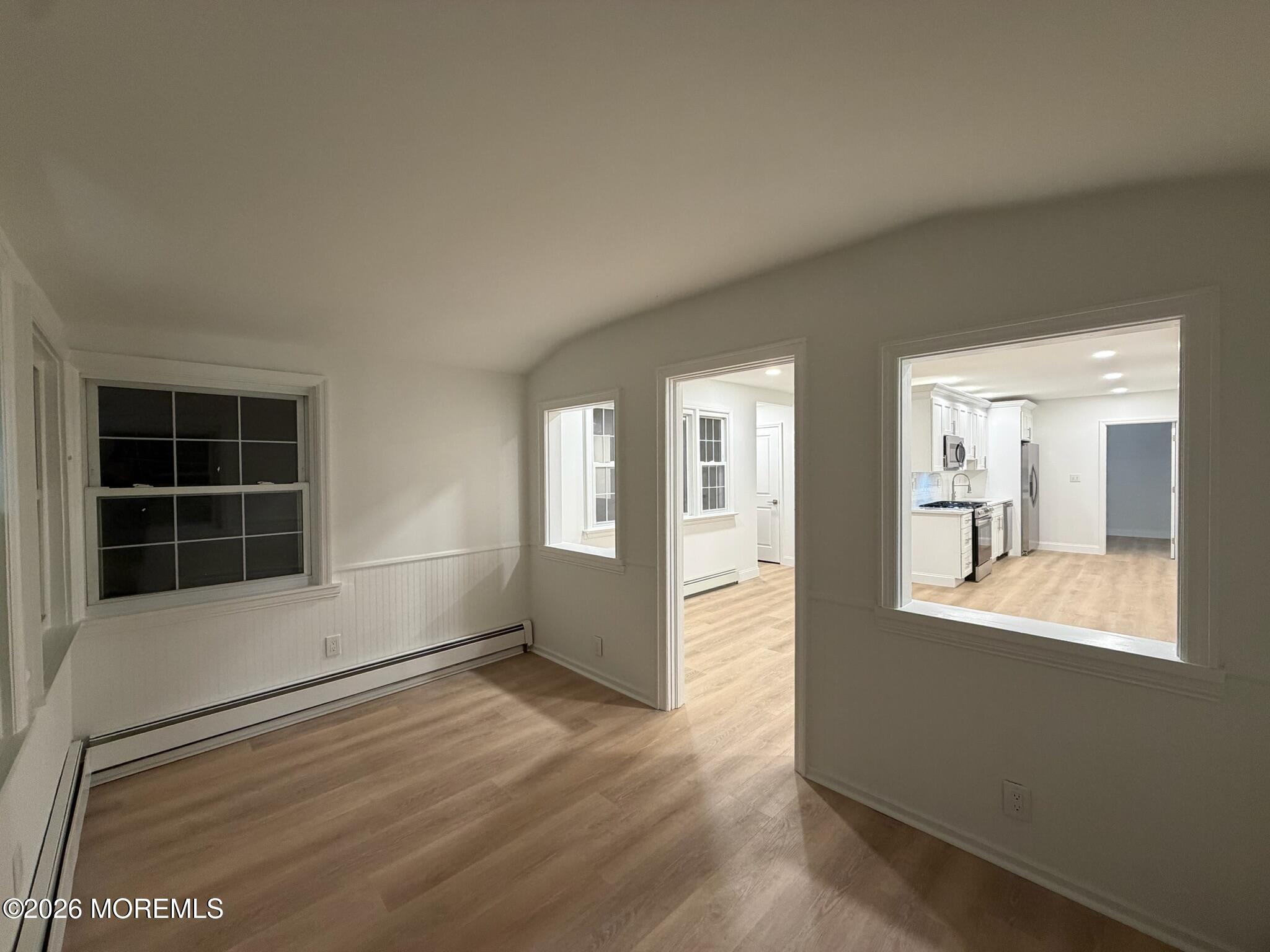 13 Pittenger Pond Road Freehold, NJ 07728 - Photo 2 of 16 an empty room with wooden floor and windows