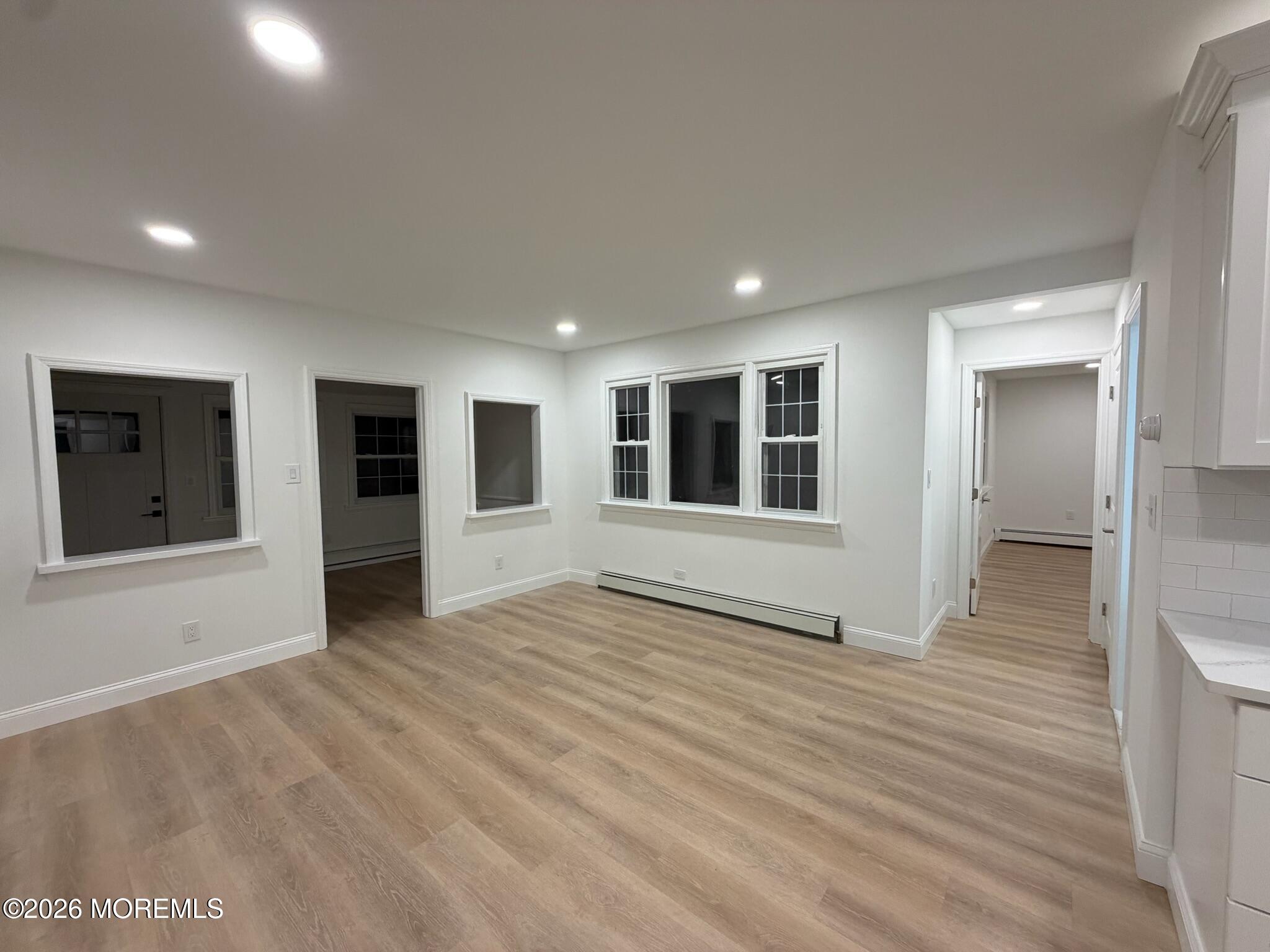 13 Pittenger Pond Road Freehold, NJ 07728 - Photo 5 of 16 a view of an empty room with wooden floor and windows