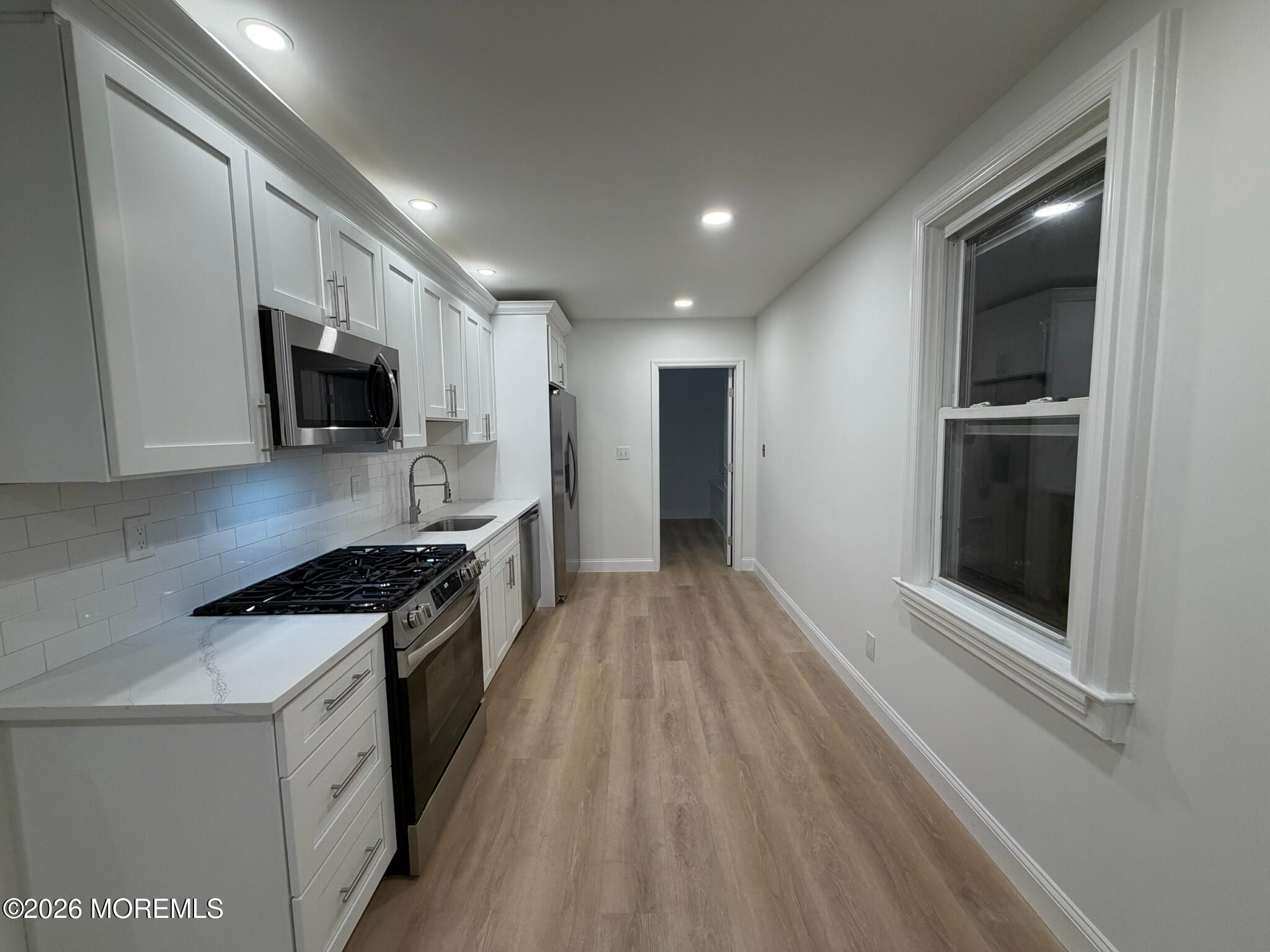 13 Pittenger Pond Road Freehold, NJ 07728 - Photo 6 of 16 a kitchen with stainless steel appliances granite countertop a stove a sink and a refrigerator