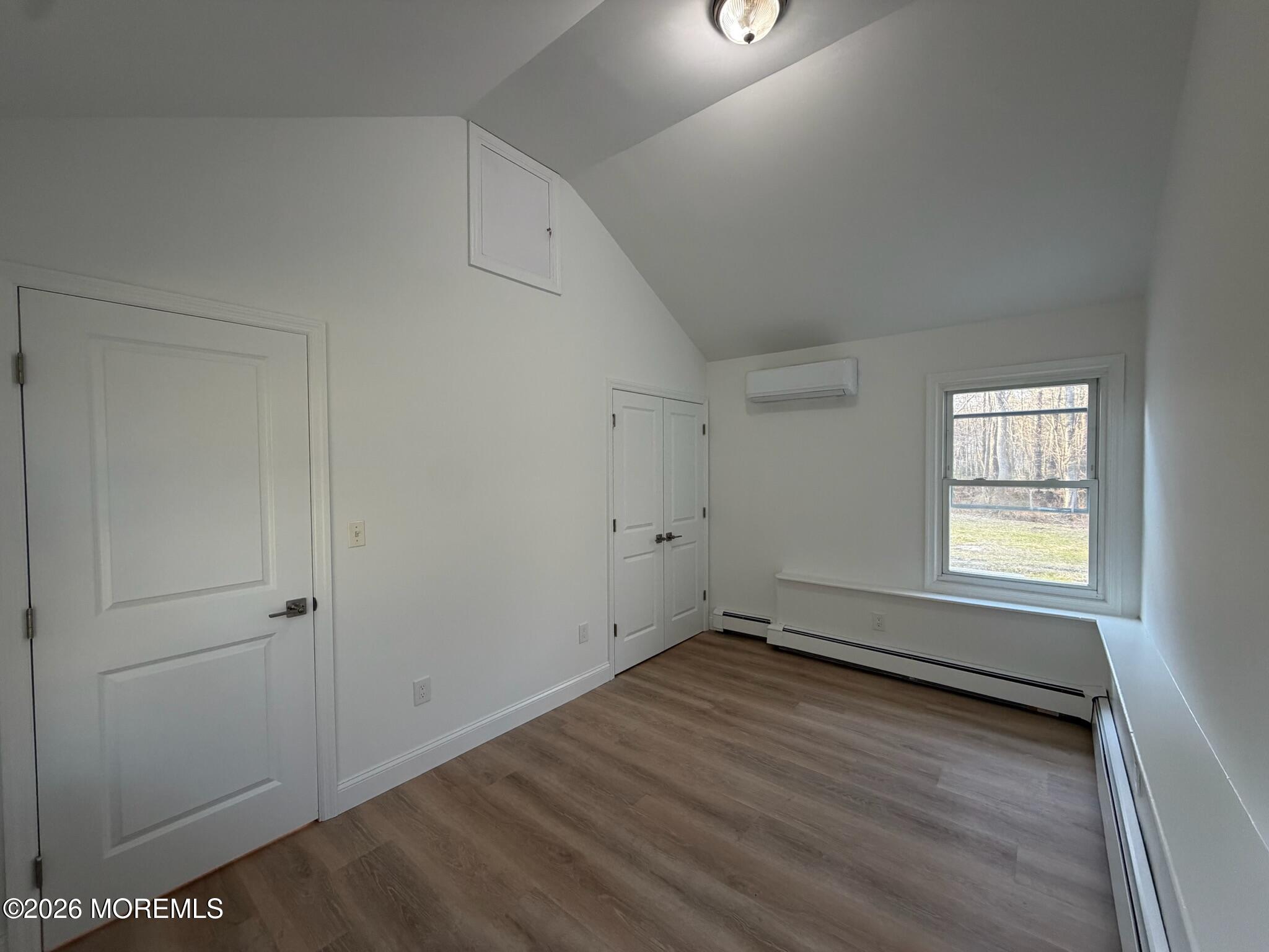 13 Pittenger Pond Road Freehold, NJ 07728 - Photo 8 of 16 an empty room with wooden floor and windows