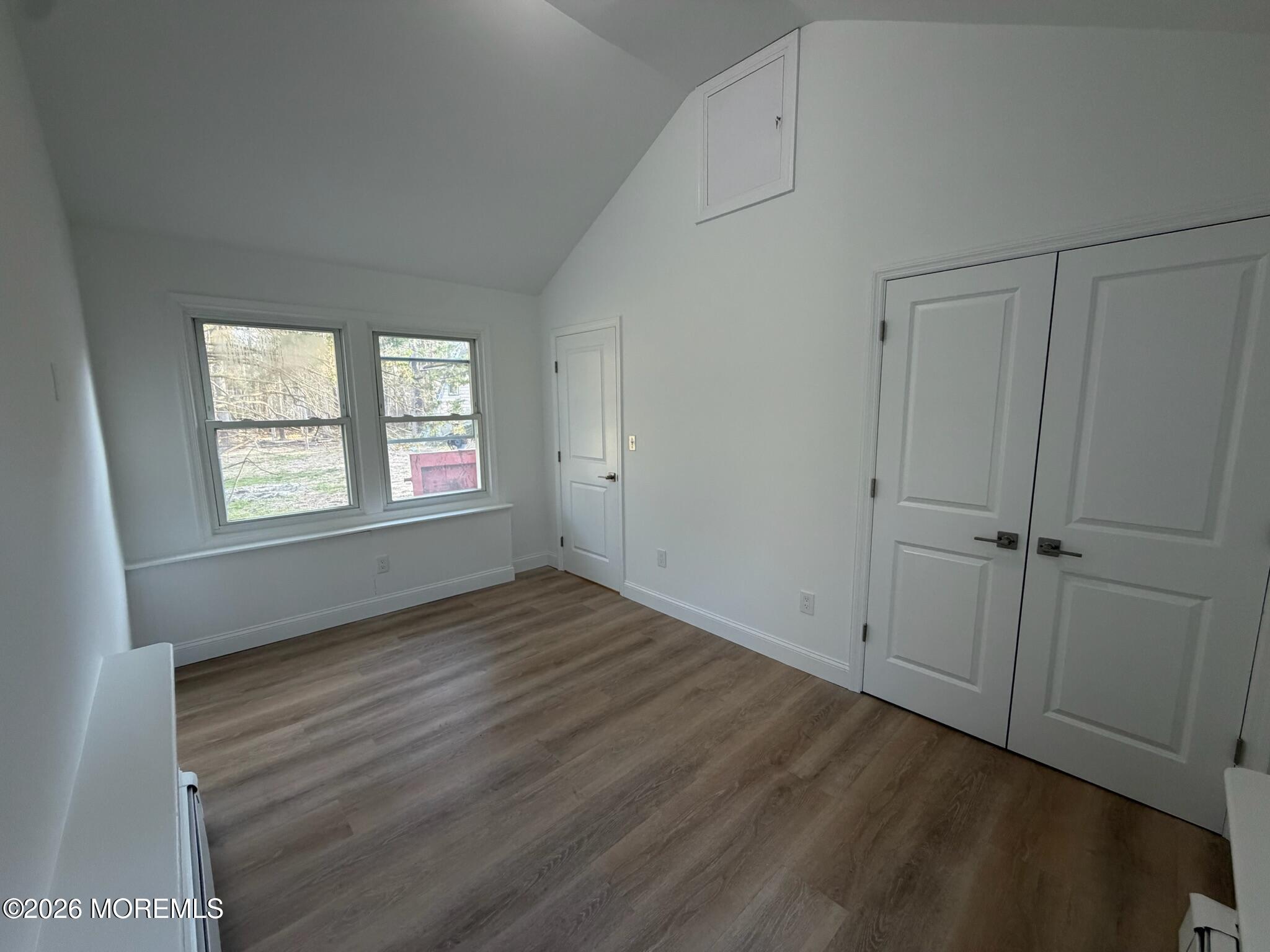 13 Pittenger Pond Road Freehold, NJ 07728 - Photo 9 of 16 a view of an empty room with wooden floor and a window