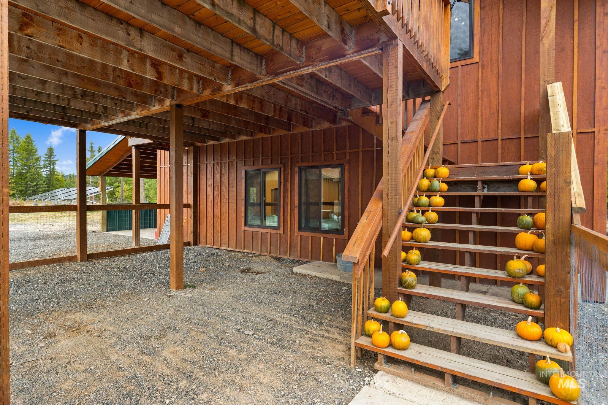 3989 East Mountain Road Anatone, WA 99401 - Photo 39 of 49 Wood-clad exterior with multiple windows and an exterior wooden staircase