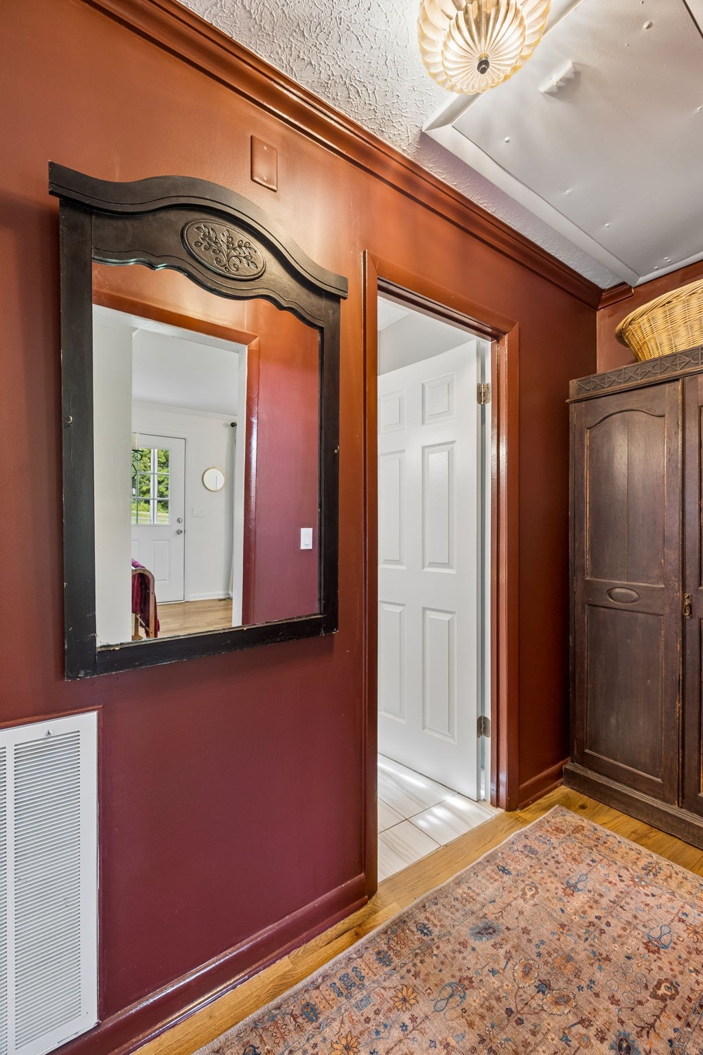 1326 Shahan Road Pleasant View, TN 37146 - Photo 16 of 41 a view of a hallway with wooden floor and a mirror on a dresser
