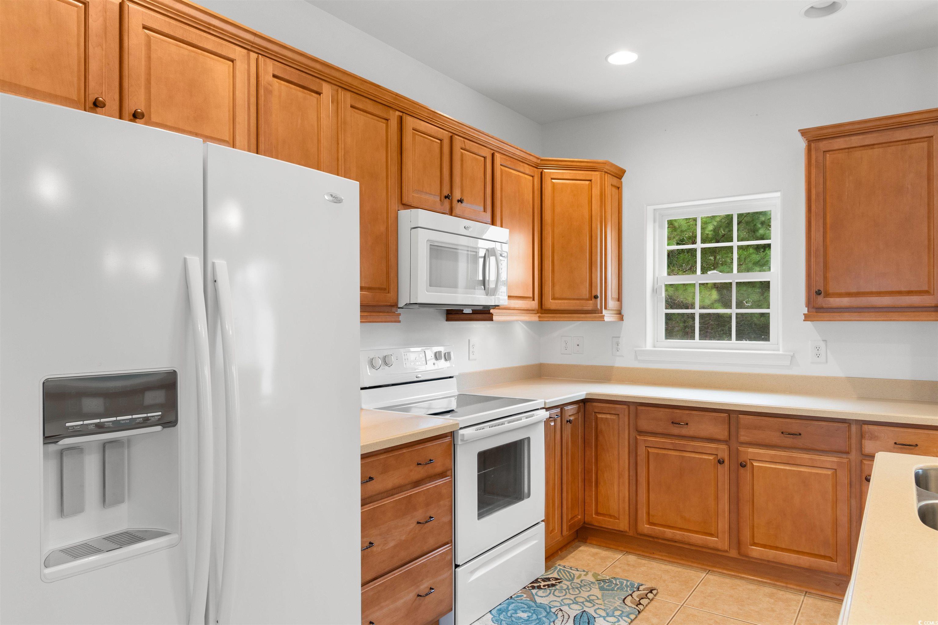 141 Terracina Circle Myrtle Beach, SC 29588 - Photo 11 of 40 Kitchen with white appliances and light tile patte