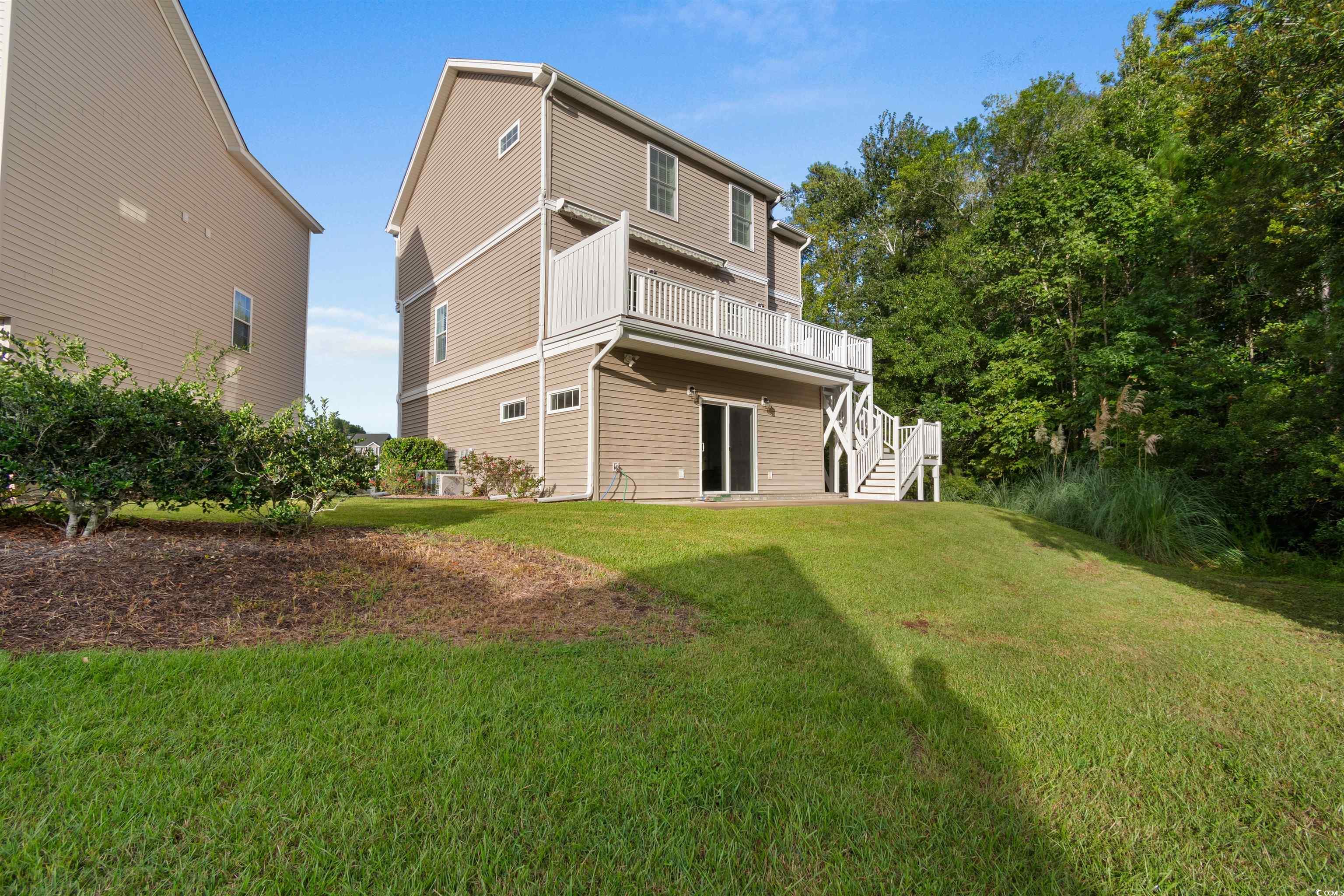 141 Terracina Circle Myrtle Beach, SC 29588 - Photo 32 of 40 Rear view of property with a lawn