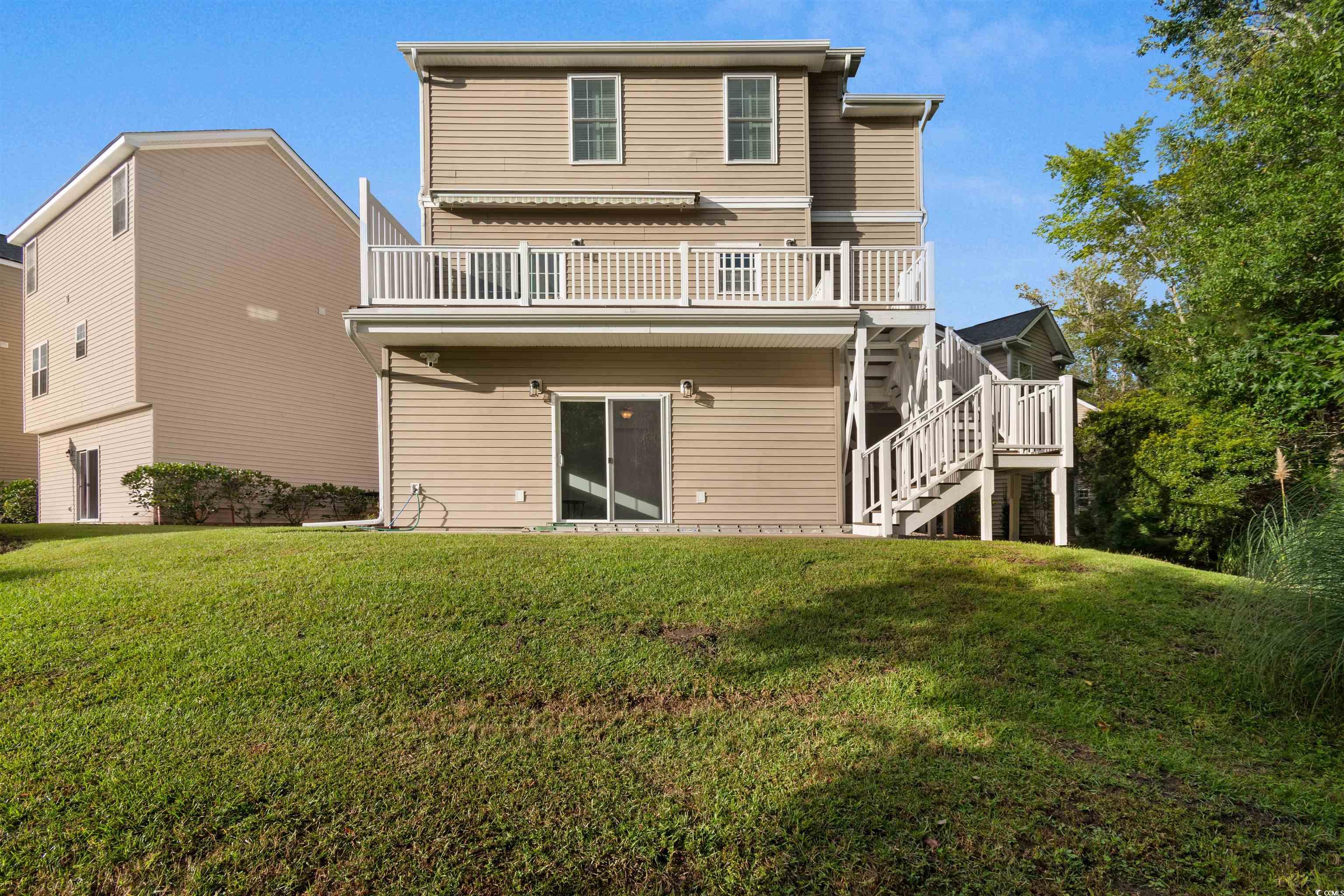 141 Terracina Circle Myrtle Beach, SC 29588 - Photo 33 of 40 Back of house featuring a wooden deck and a yard