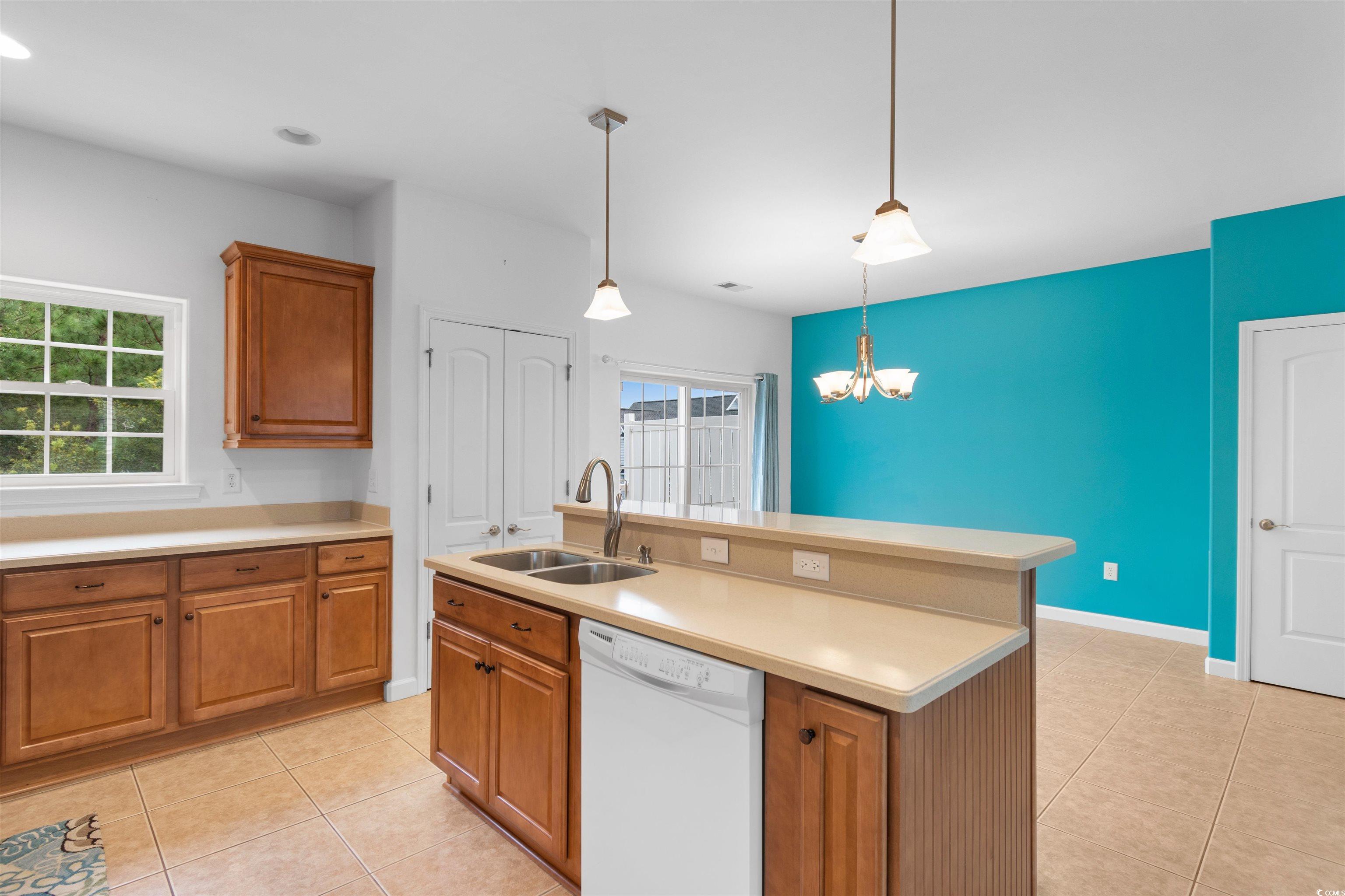 141 Terracina Circle Myrtle Beach, SC 29588 - Photo 6 of 40 Kitchen with hanging light fixtures, light tile pa