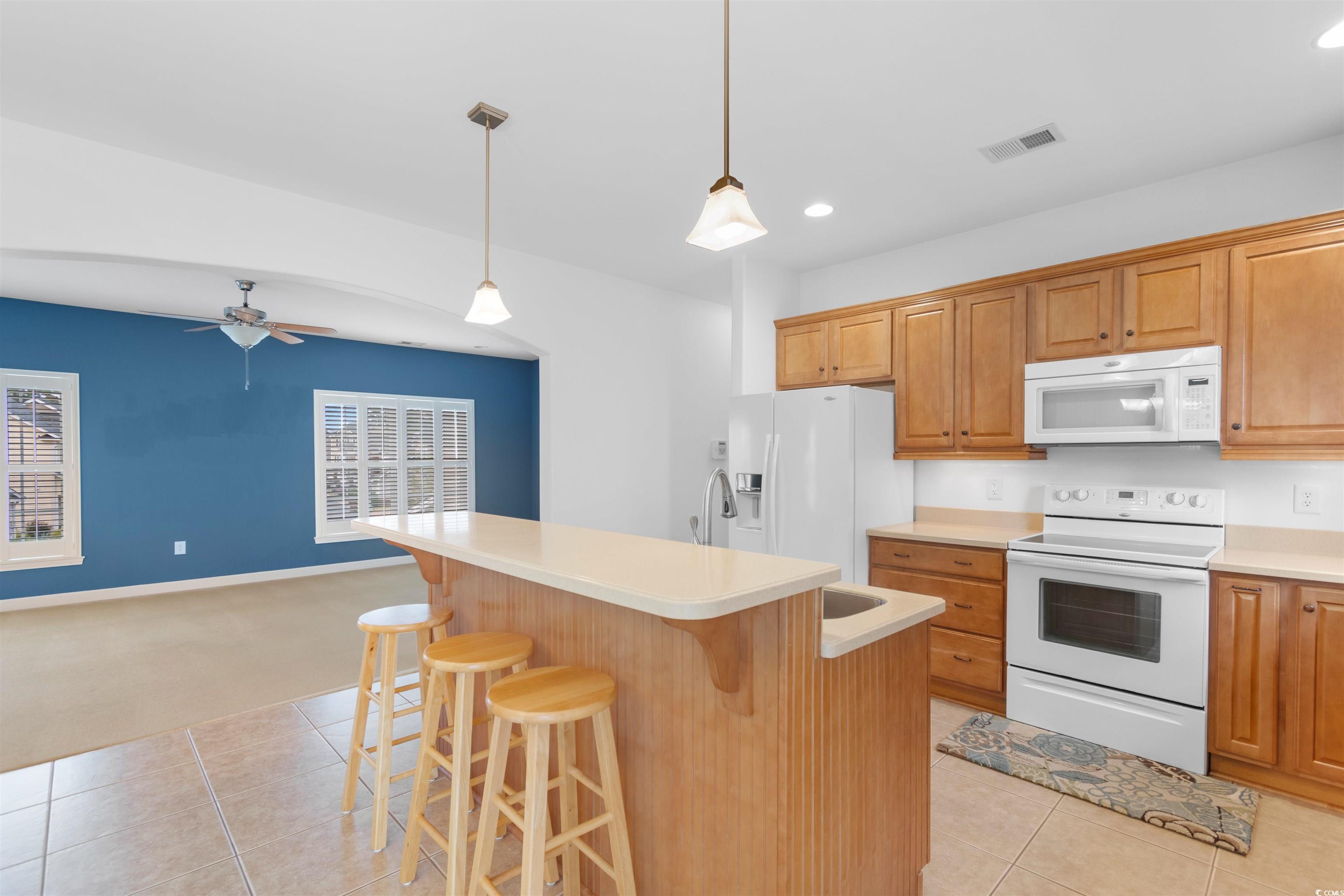 141 Terracina Circle Myrtle Beach, SC 29588 - Photo 8 of 40 Kitchen featuring white appliances, a kitchen isla