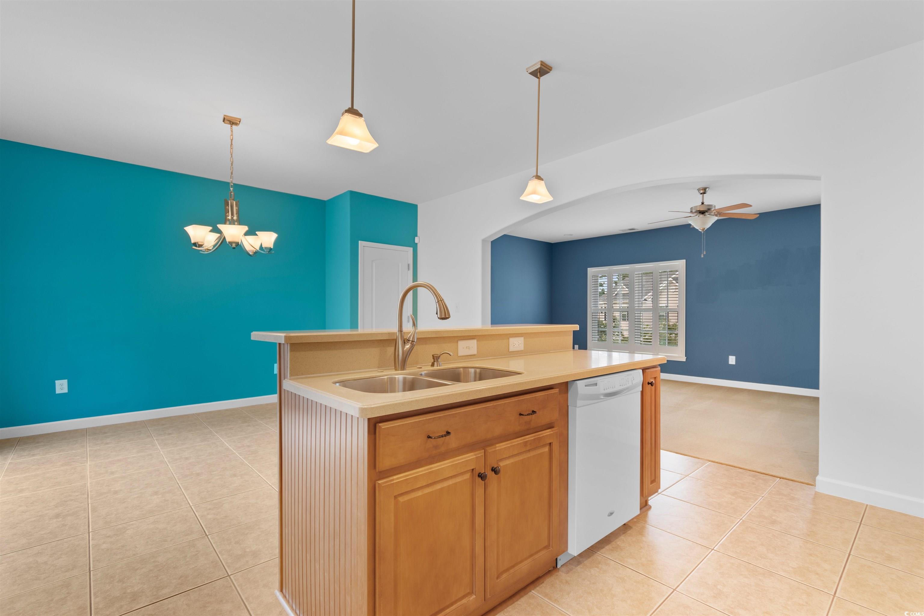 141 Terracina Circle Myrtle Beach, SC 29588 - Photo 9 of 40 Kitchen featuring an island with sink, hanging lig