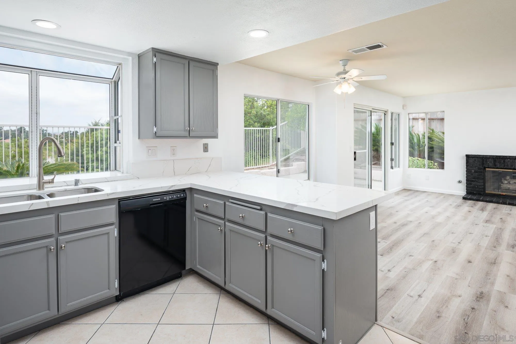 665 Montage Road Oceanside, CA 92057 - Photo 13 of 52 a kitchen with a sink window and cabinets