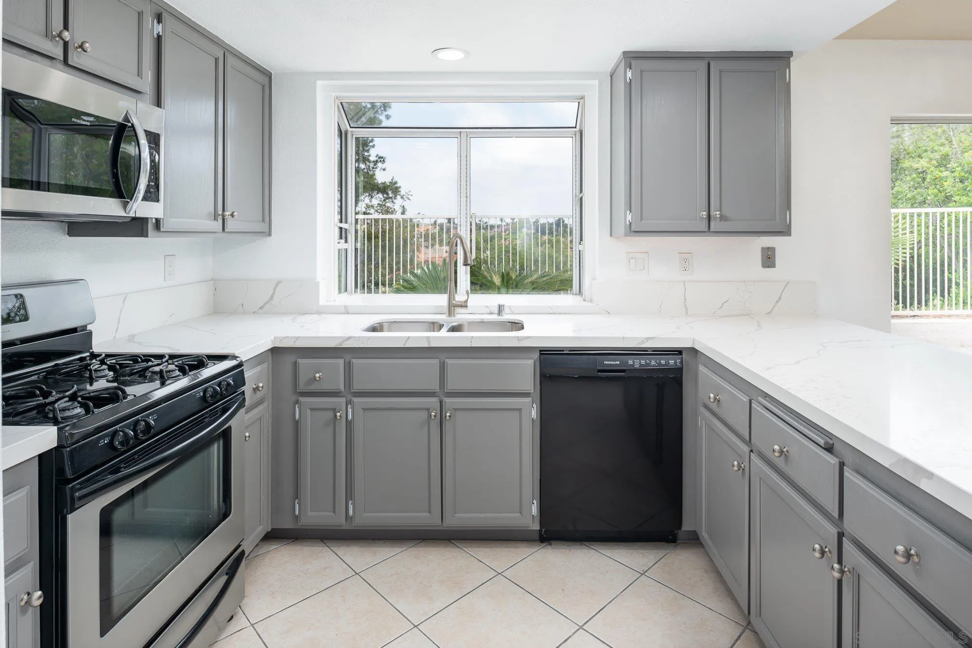 665 Montage Road Oceanside, CA 92057 - Photo 14 of 52 a kitchen with a sink stove and microwave