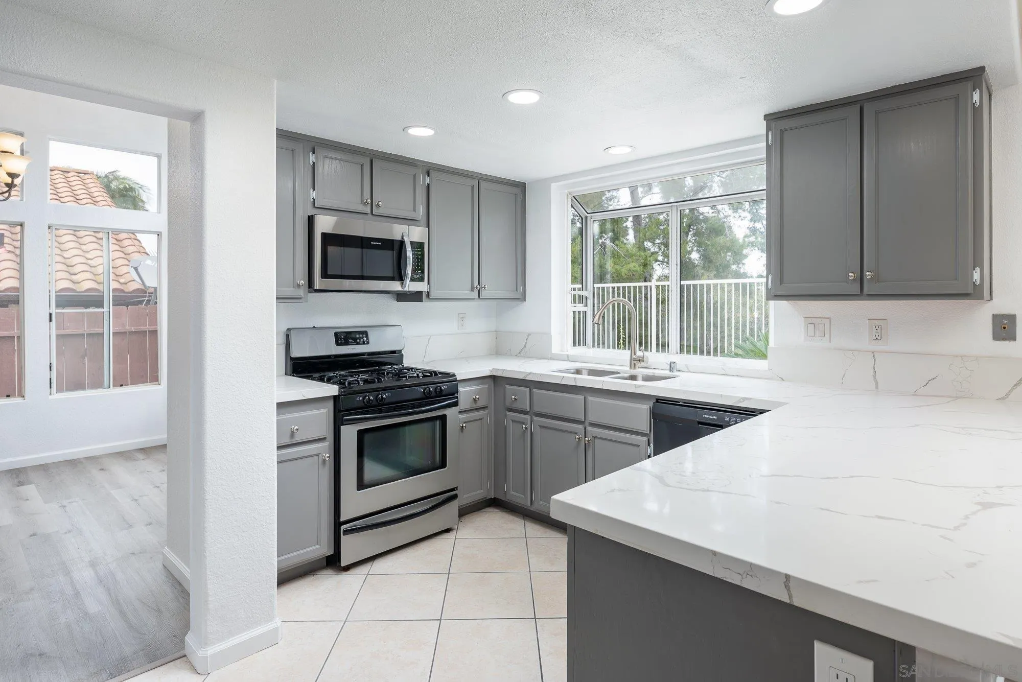 665 Montage Road Oceanside, CA 92057 - Photo 15 of 52 a kitchen with a sink stove and microwave