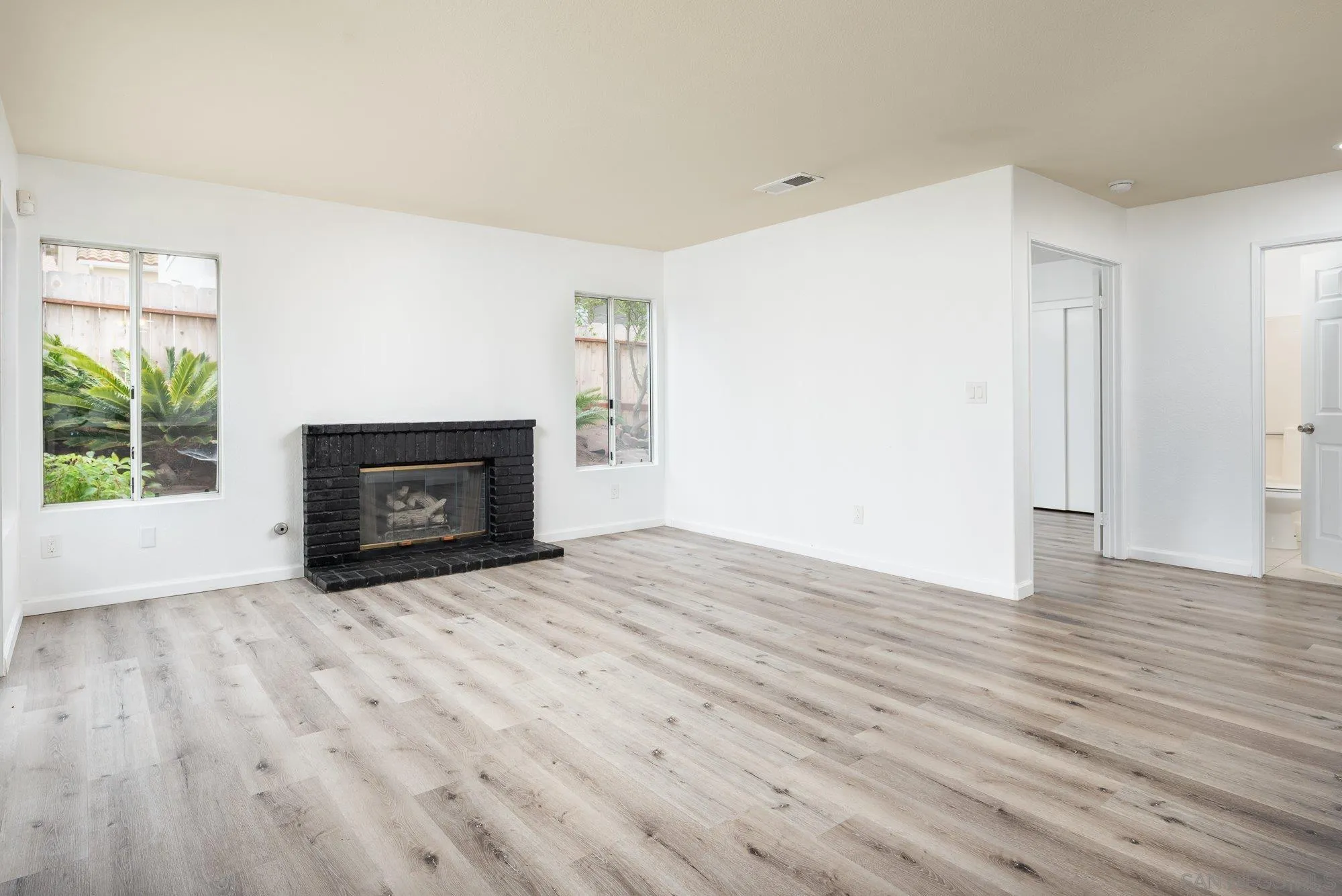 665 Montage Road Oceanside, CA 92057 - Photo 22 of 52 a view of empty room with wooden floor and fireplace