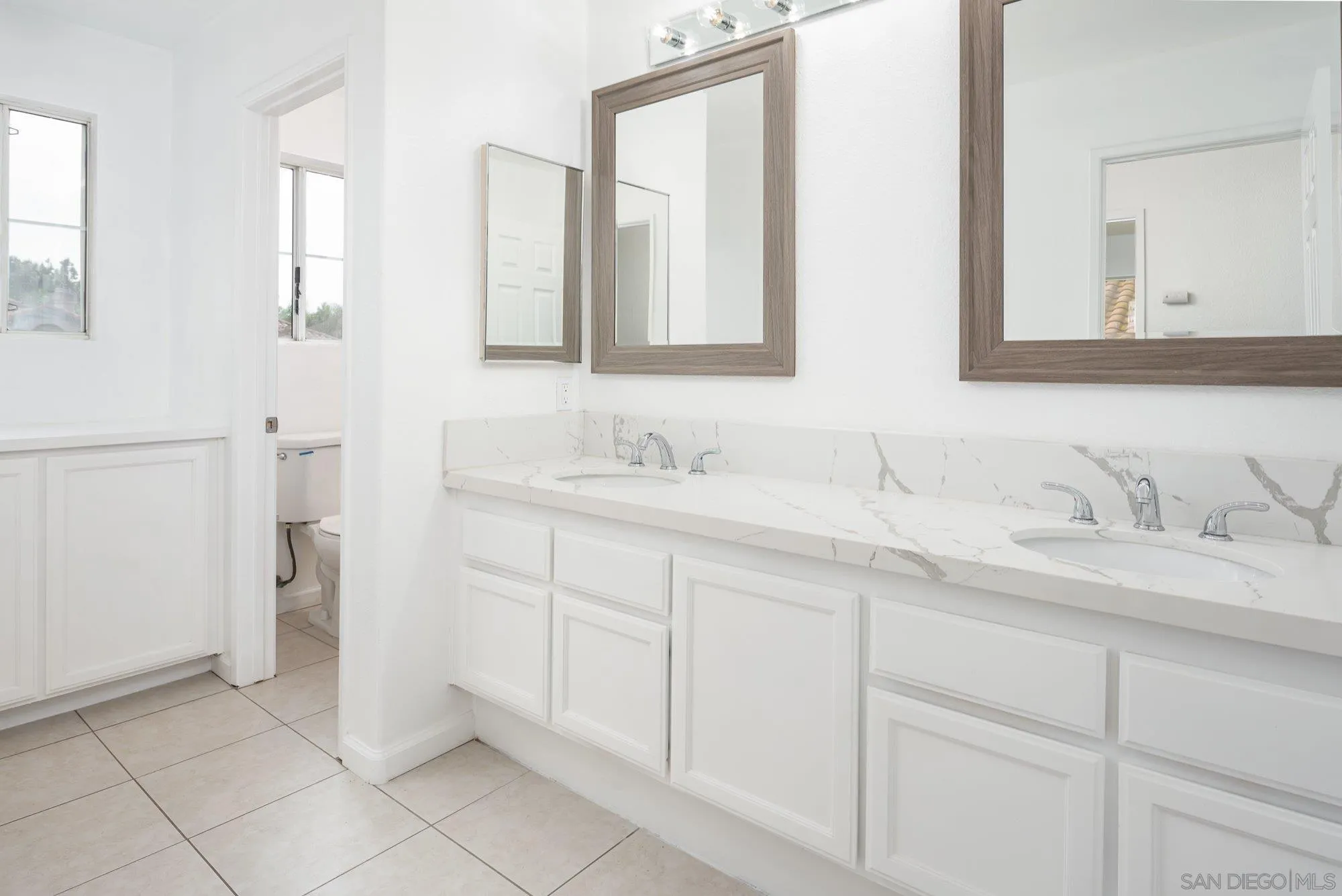 665 Montage Road Oceanside, CA 92057 - Photo 34 of 52 a bathroom with a sink and a mirror