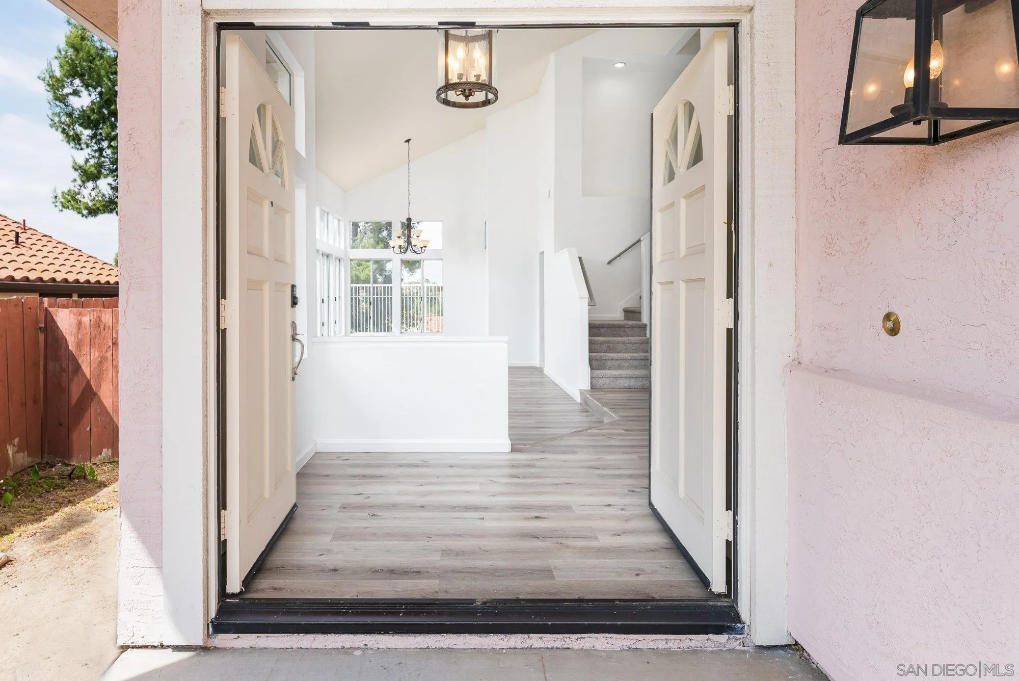 665 Montage Road Oceanside, CA 92057 - Photo 5 of 52 a view of a hallway with wooden floor and staircase