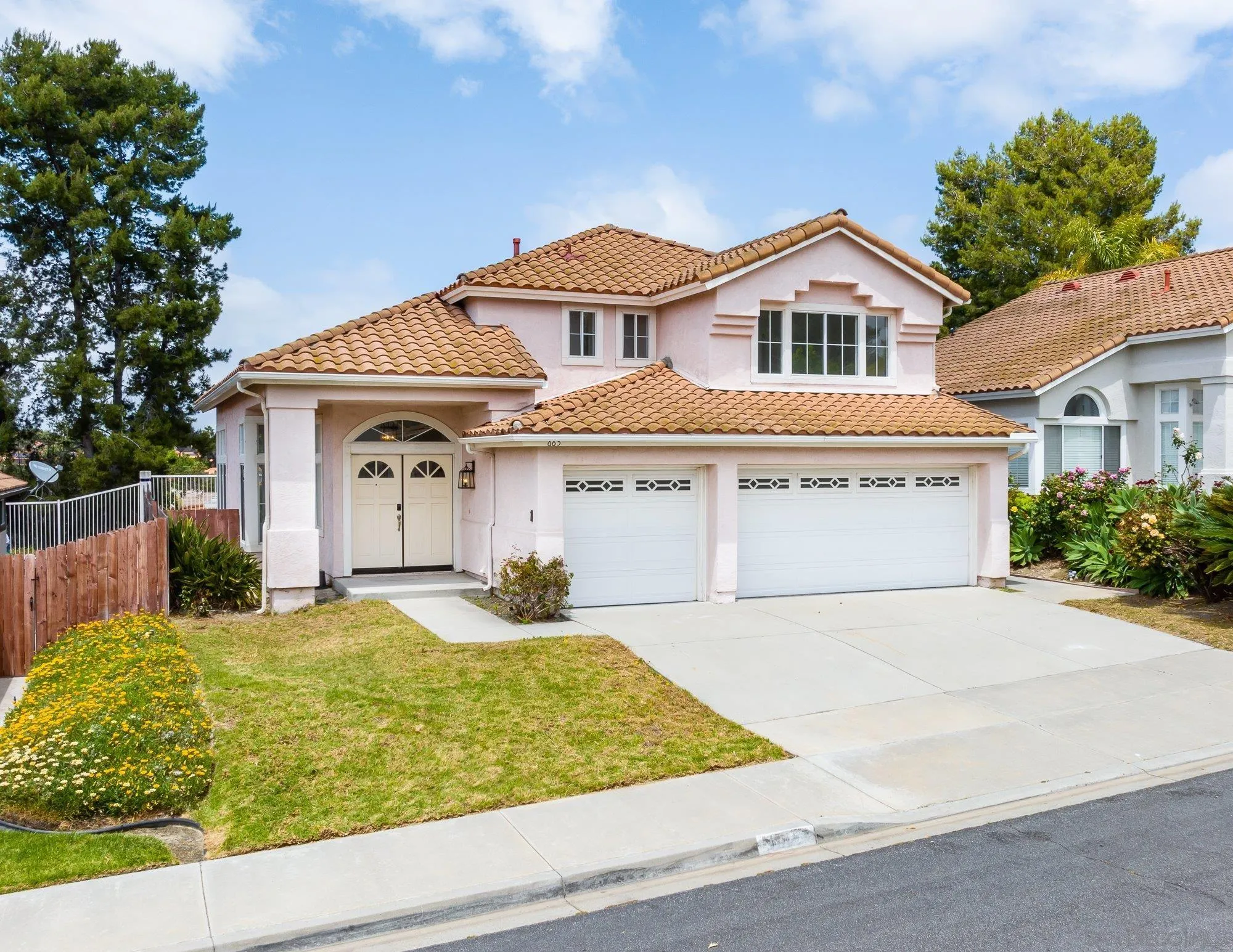 665 Montage Road Oceanside, CA 92057 - Photo 52 of 52 a view of a white house with large windows next to a yard