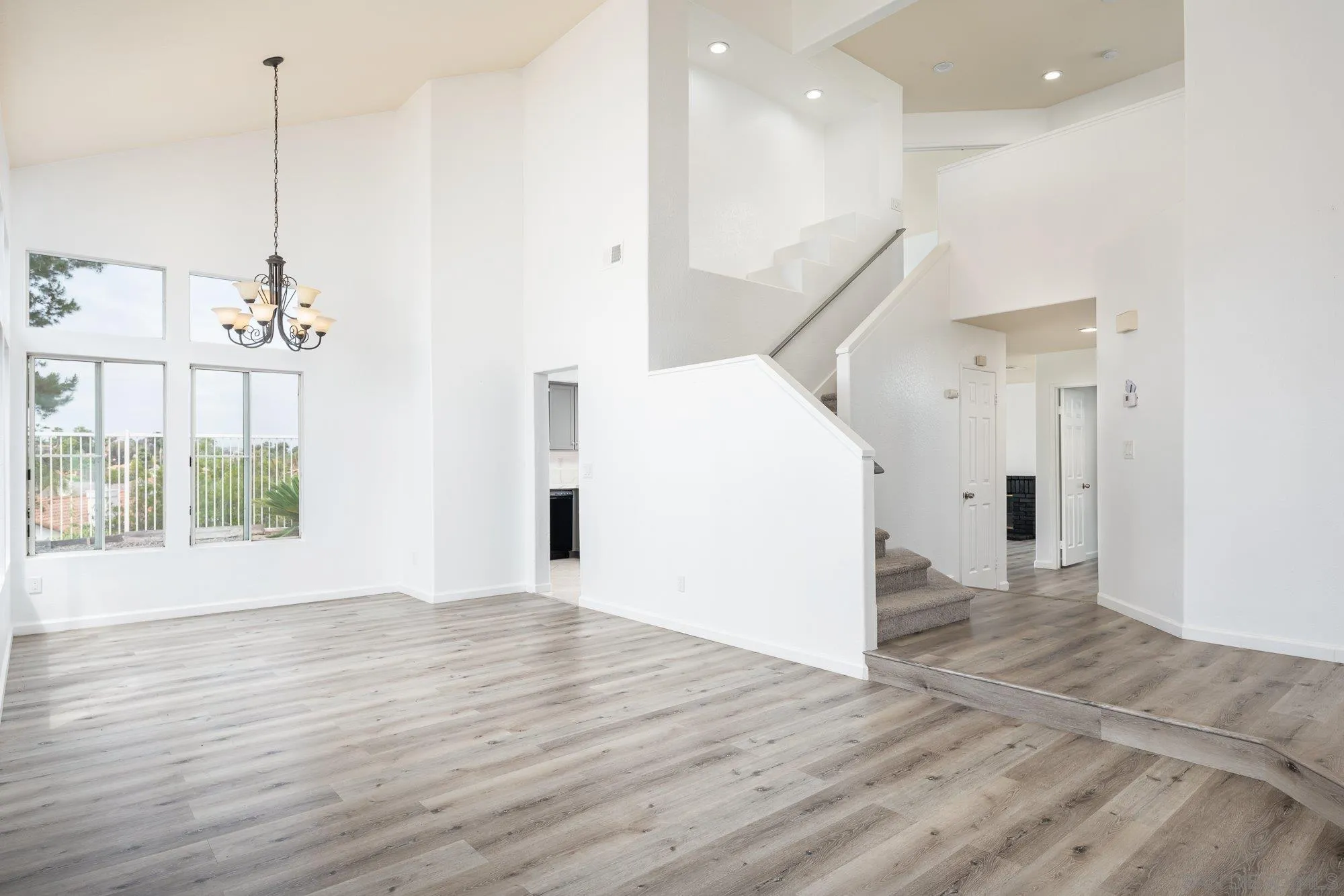 665 Montage Road Oceanside, CA 92057 - Photo 7 of 52 a view of empty room with wooden floor and windows