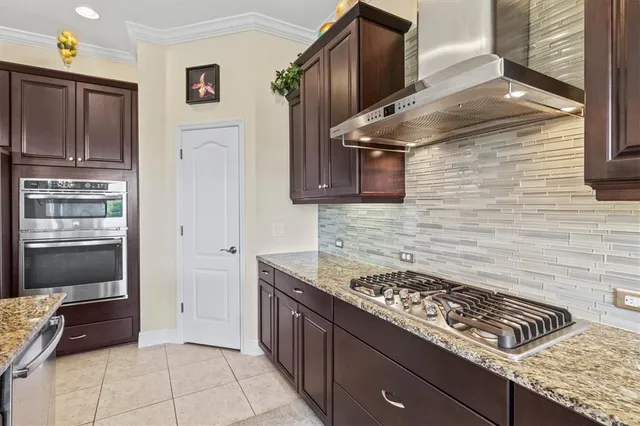 a kitchen with stainless steel appliances granite countertop a stove and a microwave