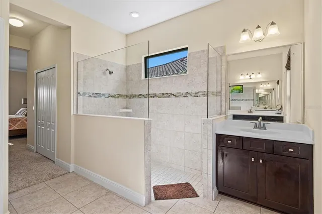 a bathroom with a double vanity sink a mirror and a shower
