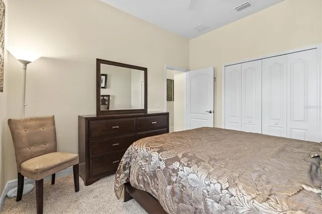 a bedroom with a bed and a chair