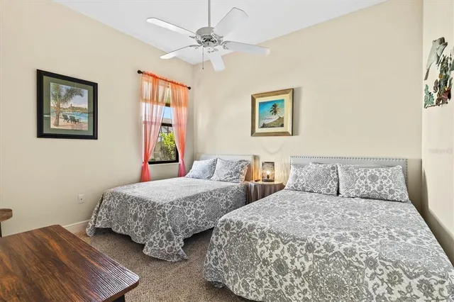 a bedroom with two beds and painting on the wall