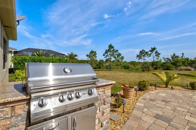 a view of swimming pool with outdoor seating and yard in back