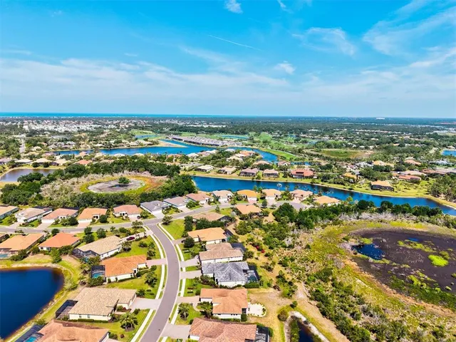 an aerial view of residential building and lake