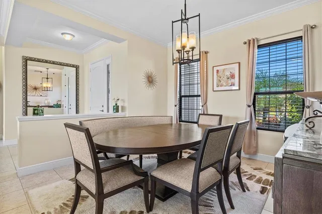 a dining room with furniture a chandelier and window