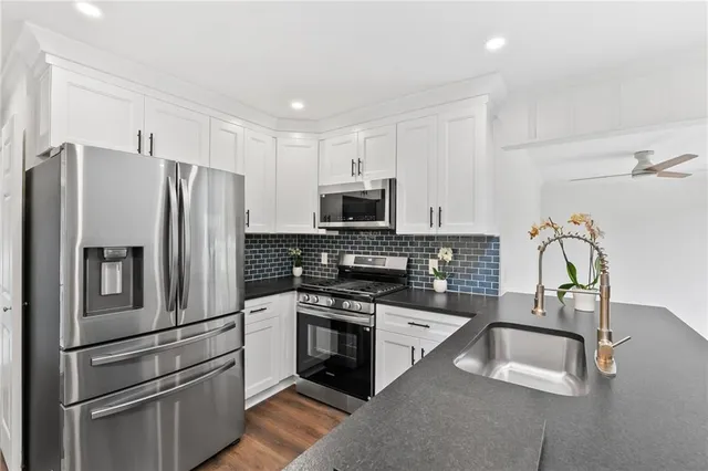 a kitchen with a sink and wooden cabinets