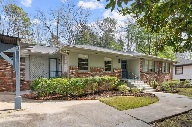 a kitchen with stainless steel appliances granite countertop a refrigerator a stove top oven a sink dishwasher and white cabinets