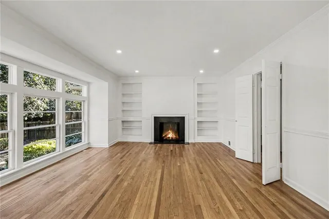 a bedroom with a bed and a dresser next to a window