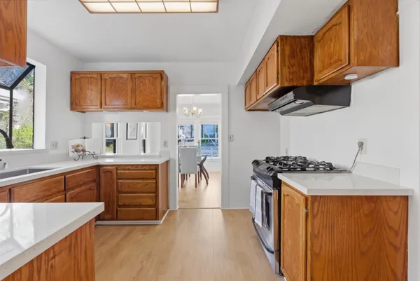 a kitchen with stainless steel appliances granite countertop a sink stove and refrigerator