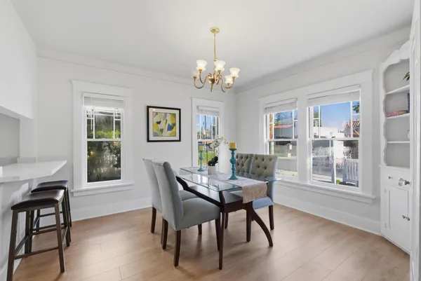 a view of a dining room with furniture window and wooden floor