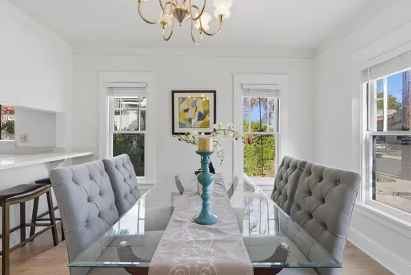 a living room with furniture chandelier and a large window