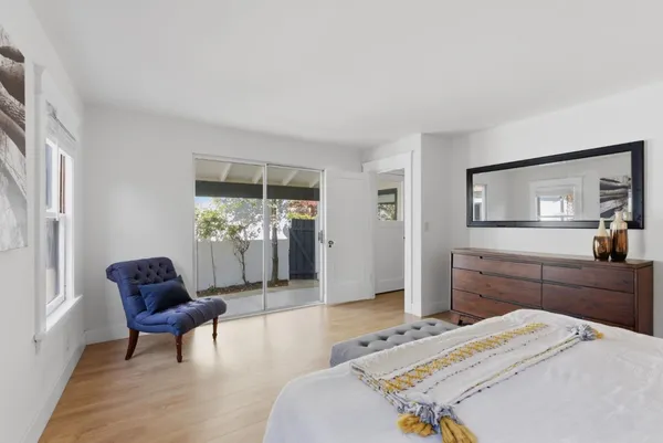 a bedroom with a bed and a chair