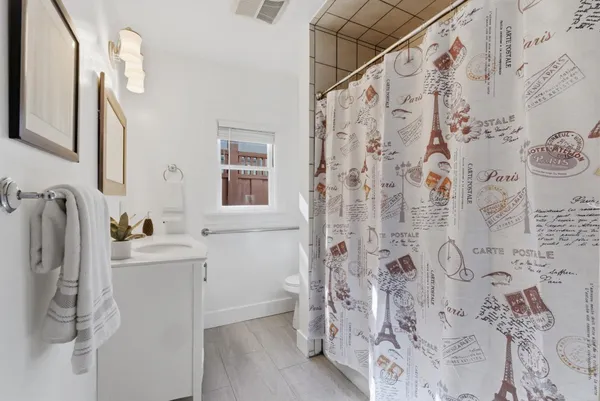 a bathroom with a sink and mirror with toilet