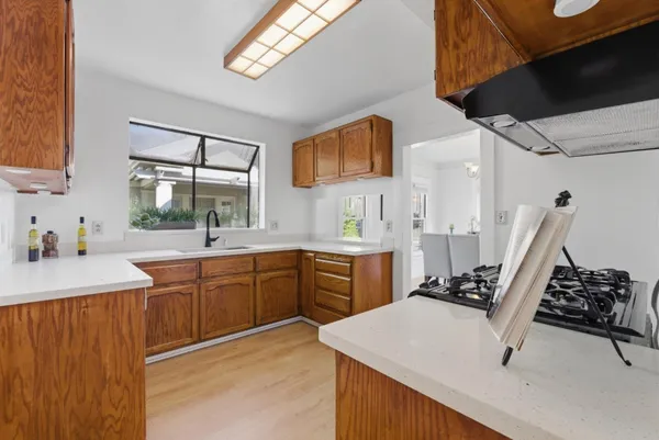a kitchen with sink cabinets and stove