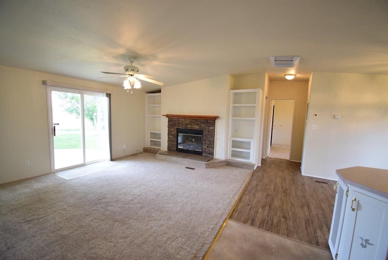 19548 B50 Road Delta, CO 81416 - Photo 11 of 37 an empty room with windows and fireplace