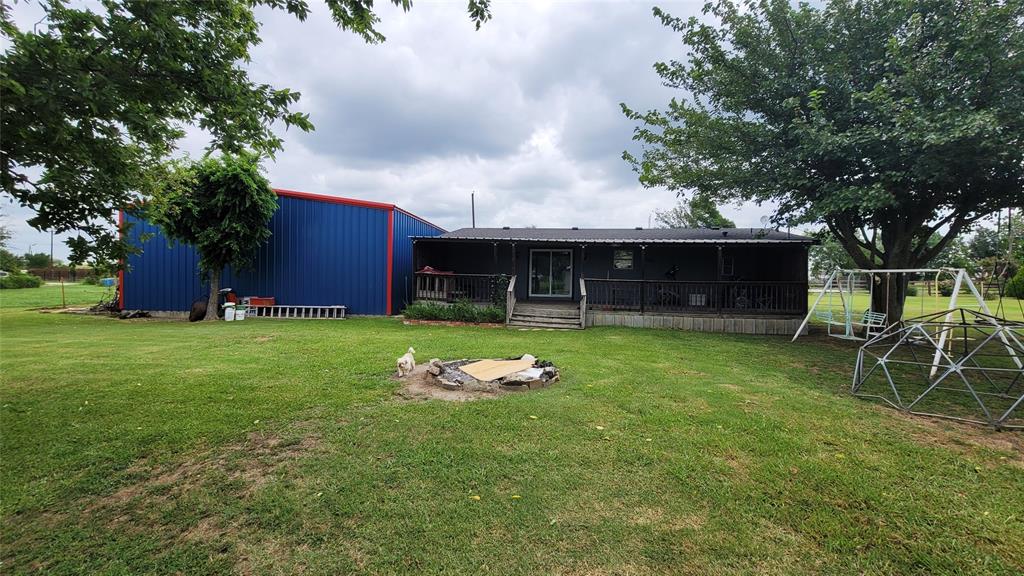 104 Mimosa Way Venus, TX 76084 - Photo 16 of 37 a backyard of a house with table and chairs plants and large tree