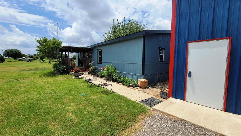 104 Mimosa Way Venus, TX 76084 - Photo 19 of 37 a backyard of a house with plants and outdoor seating