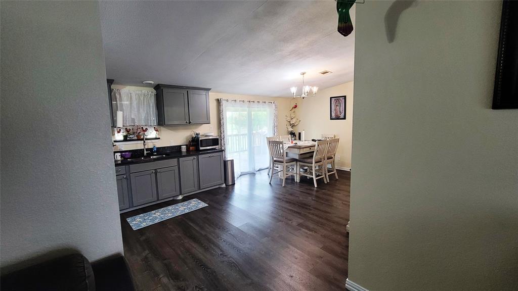 104 Mimosa Way Venus, TX 76084 - Photo 6 of 37 a kitchen with granite countertop a stove and cabinets