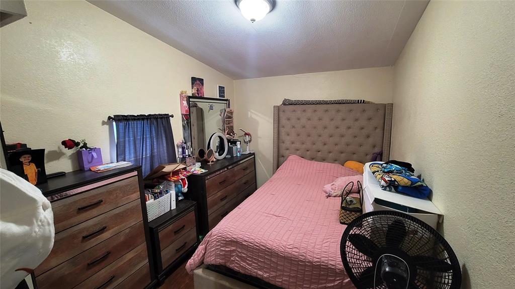 104 Mimosa Way Venus, TX 76084 - Photo 7 of 37 a bedroom with a bed and wooden floor