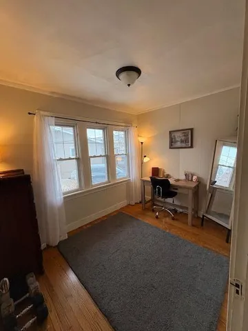 a view of a workspace with furniture and a window