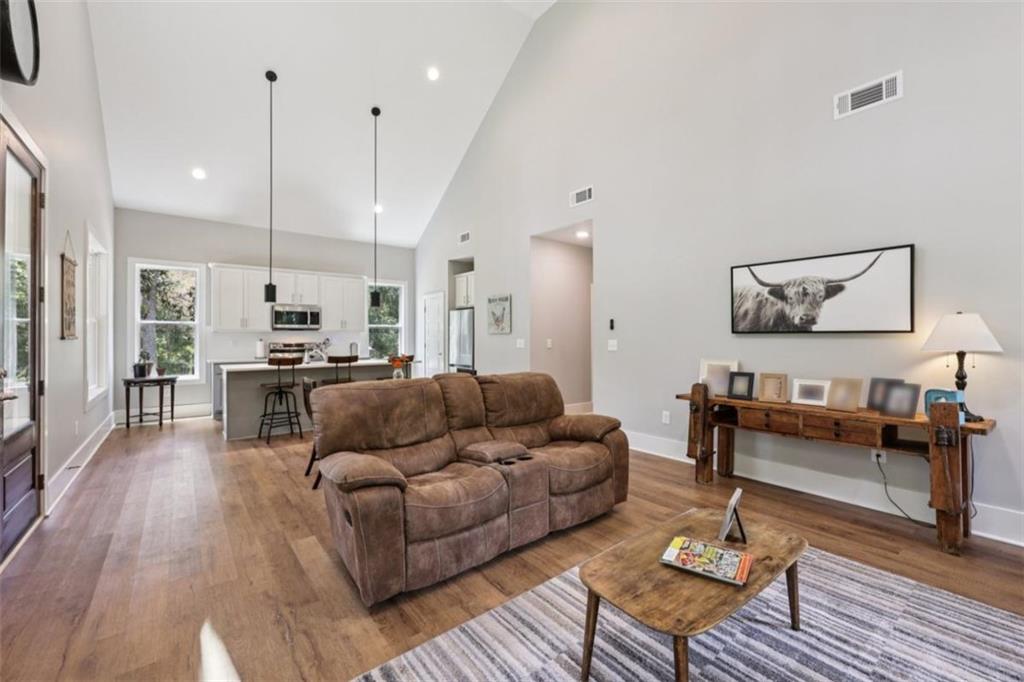 250 Stagecoach Road Oxford, GA 30054 - Photo 18 of 76 a living room with furniture kitchen view and a wooden floor