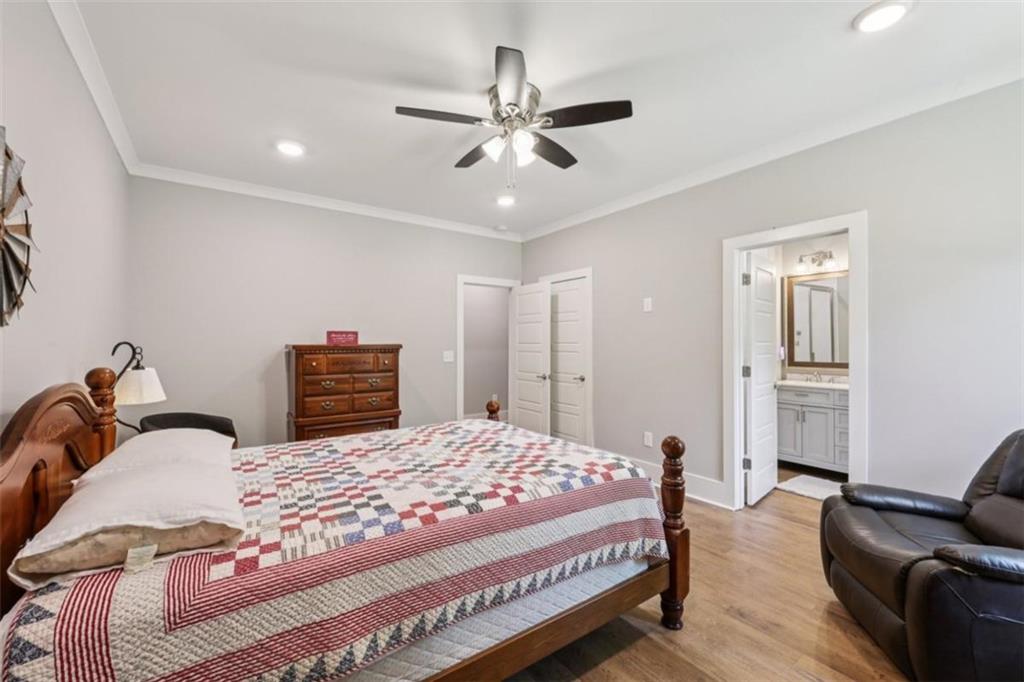 250 Stagecoach Road Oxford, GA 30054 - Photo 33 of 76 a bedroom with a bed and ceiling chandelier