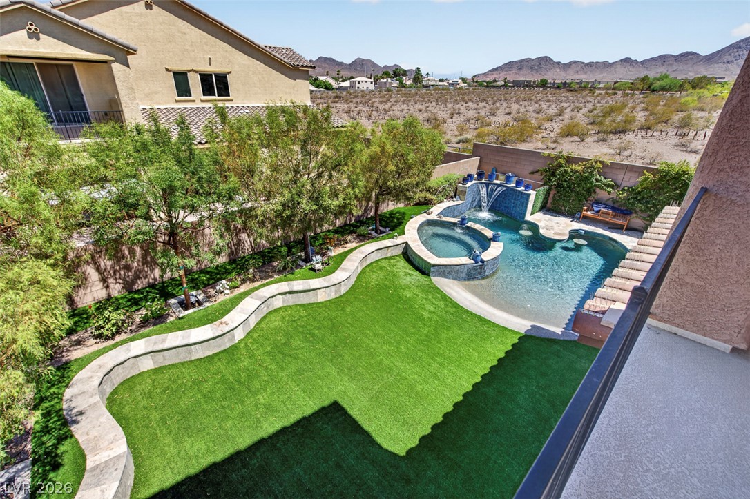 1824 Redland Ridge Street Henderson, NV 89002 - Photo 45 of 69 Backyard oasis with a refreshing pool, spa, and verdant artificial turf.