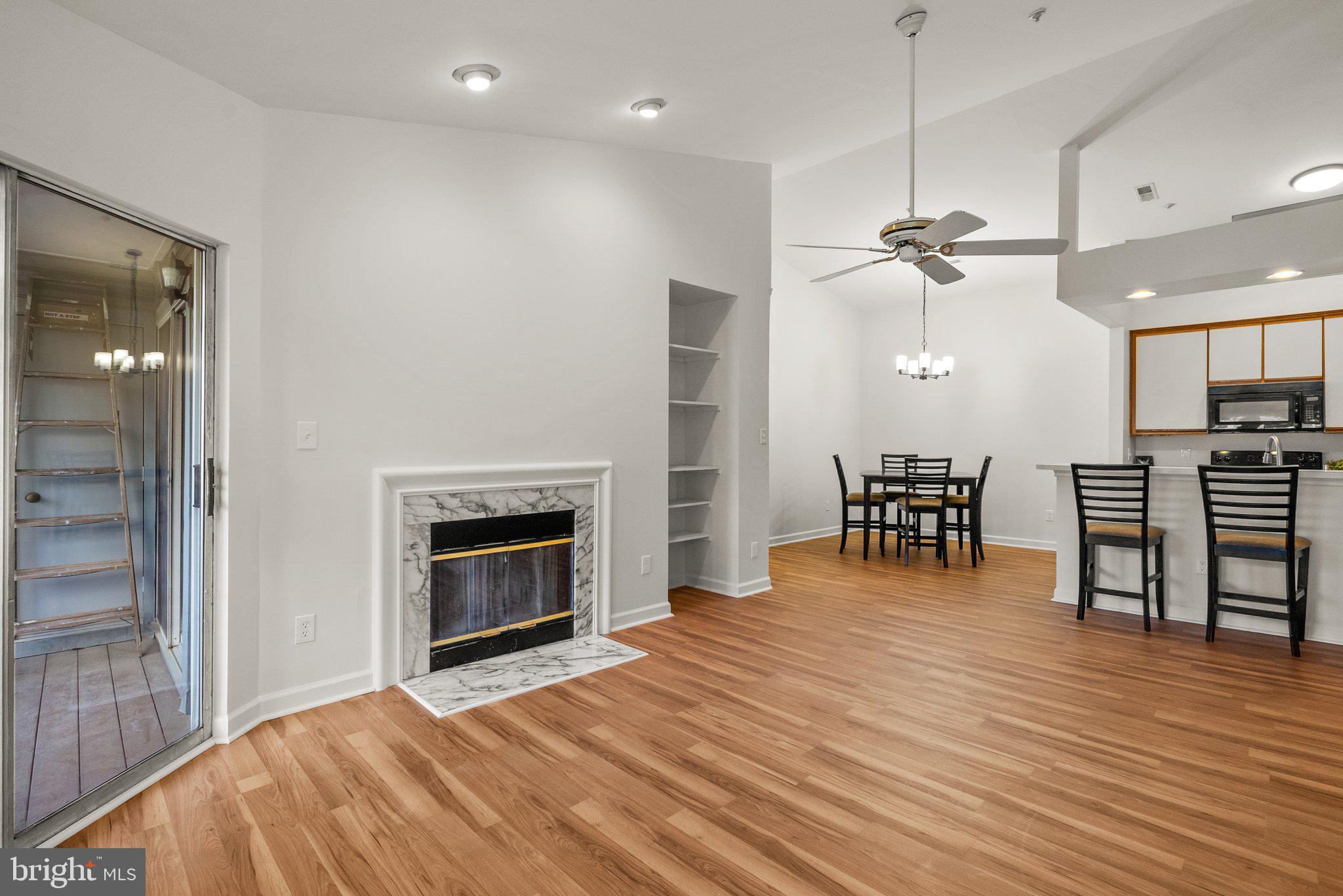 3301 Sir Thomas Drive, Unit 6B41 Silver Spring, MD 20904 - Photo 14 of 27 a view of a room with wooden floor fireplace and windows