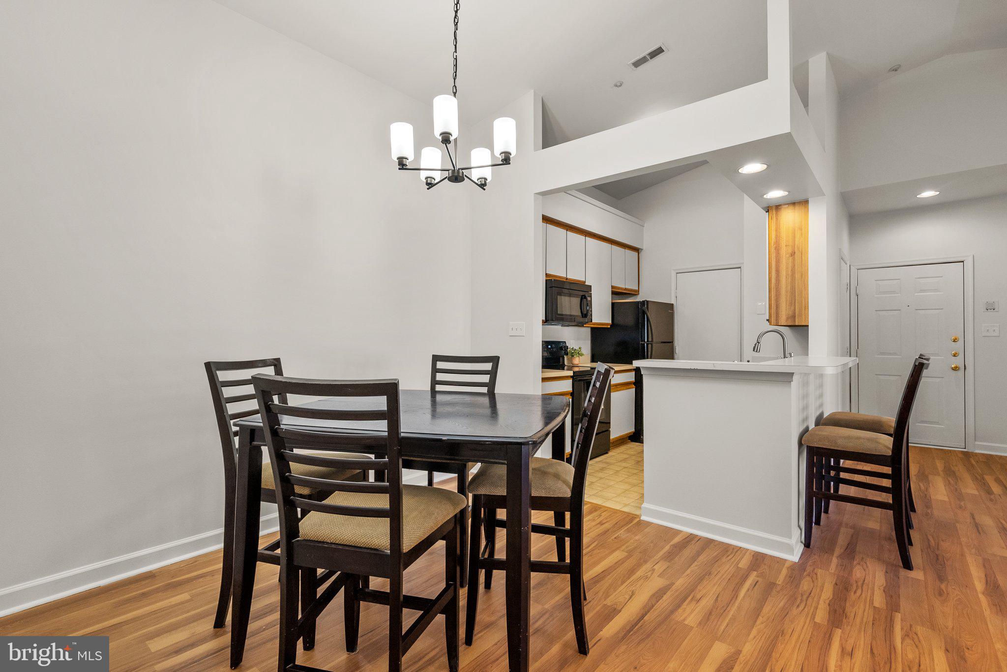 3301 Sir Thomas Drive, Unit 6B41 Silver Spring, MD 20904 - Photo 16 of 27 a view of a dining room with furniture and wooden floor