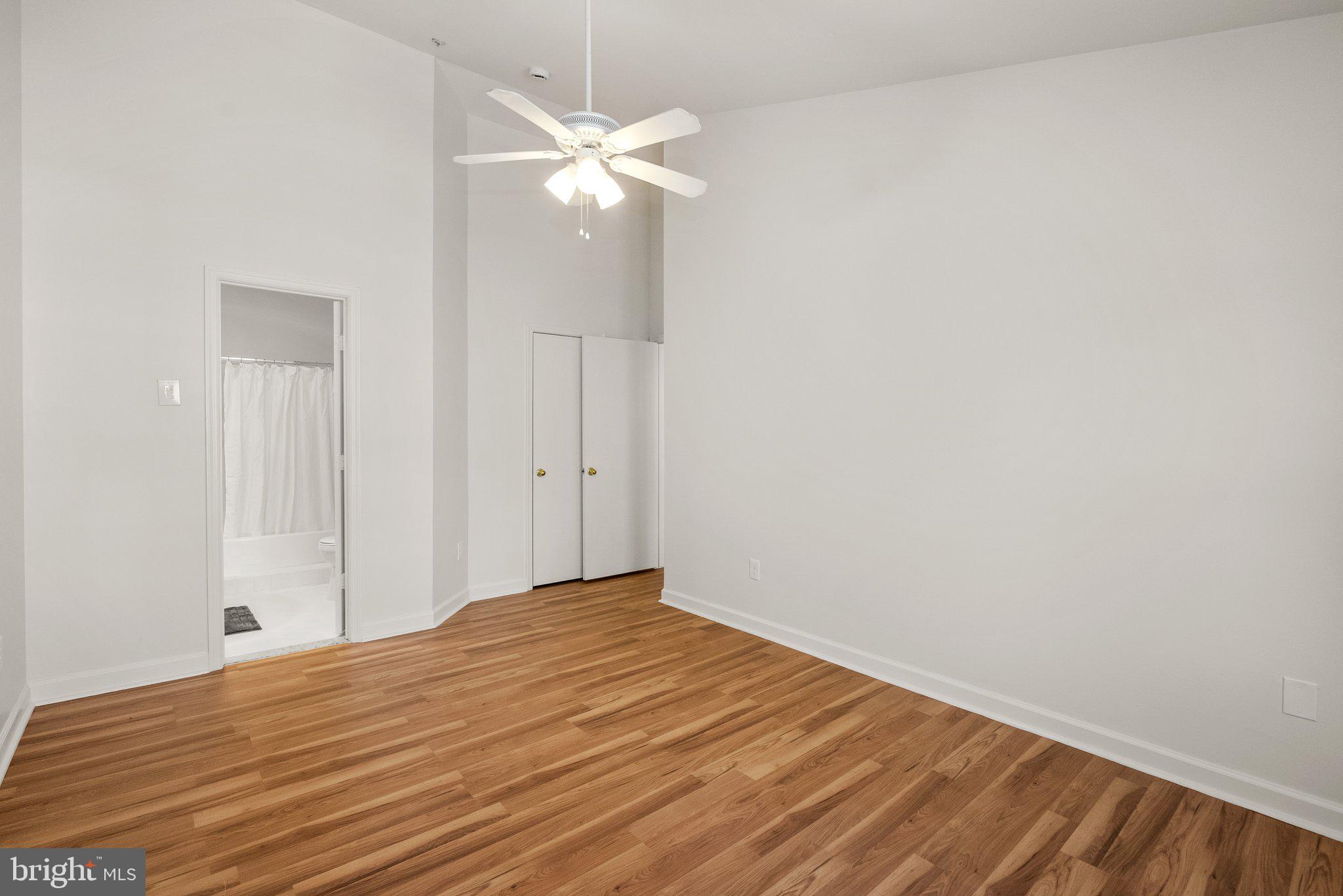 3301 Sir Thomas Drive, Unit 6B41 Silver Spring, MD 20904 - Photo 18 of 27 a view of a room with wooden floor and fan