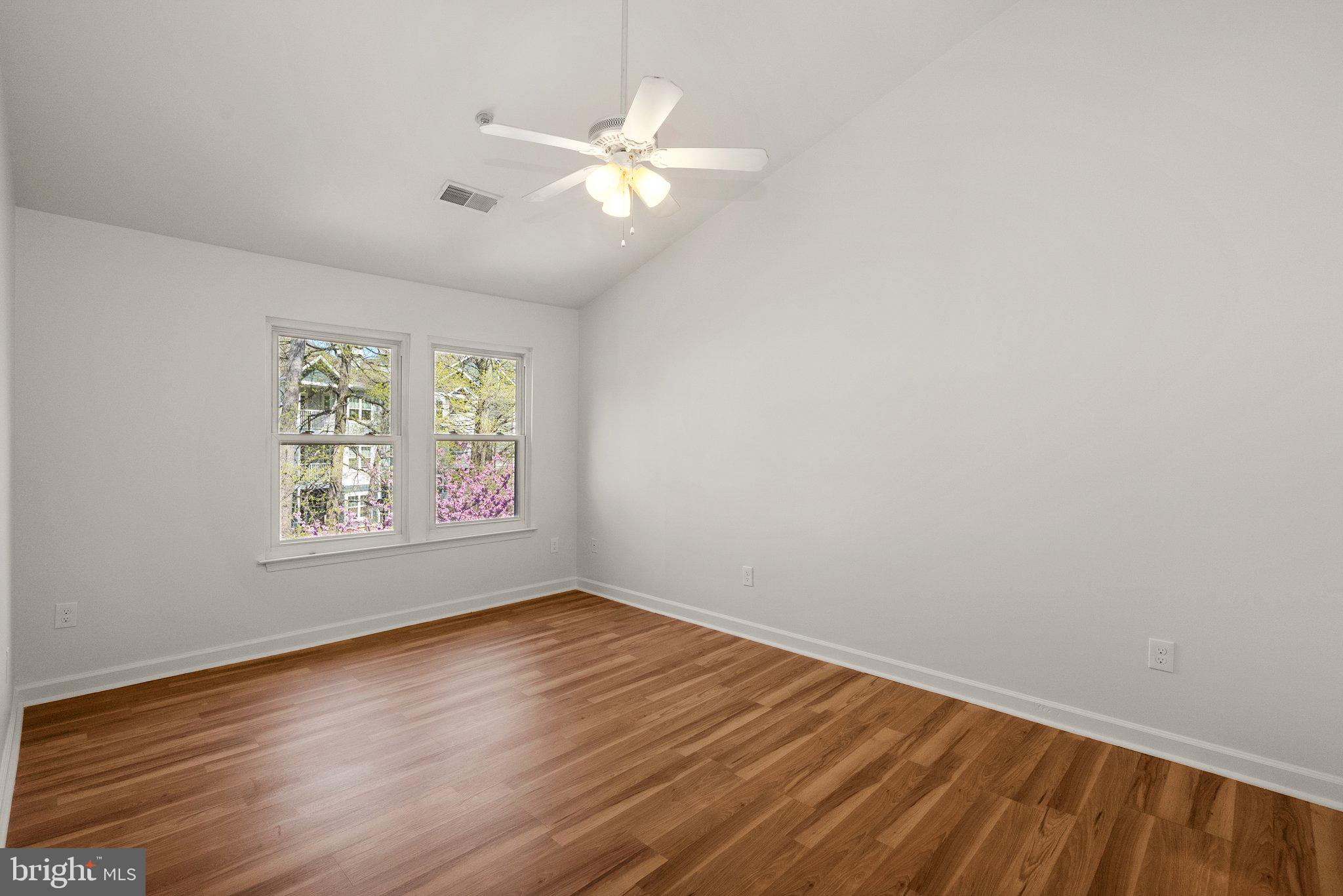 3301 Sir Thomas Drive, Unit 6B41 Silver Spring, MD 20904 - Photo 19 of 27 an empty room with wooden floor and windows